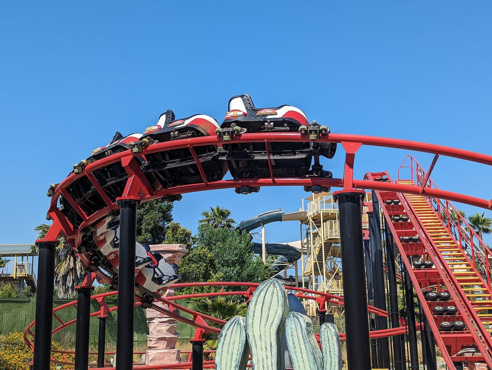 Riders on a red roller coaster at Six Flags Magic Mountain